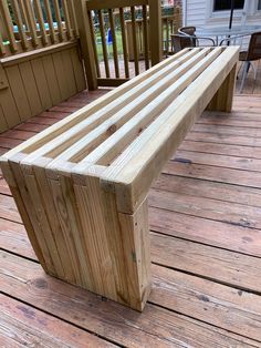 a wooden bench sitting on top of a wooden deck