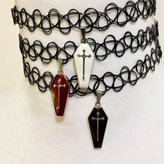 Tattoo Choker - With Coffin Charm Channel your inner 90s goth kid with this throwback tattoo choker, now with a modern, spooky twist! Made from stretchy, sturdy plastic, this choker fits like a dream and gives you that effortlessly cool, edgy look. Each choker is topped off with a coffin charm in your choice of red, black, or white - because let's face it, you can never have enough darkness in your accessories. Details: Choker Material: Stretchy, sturdy plastic (because comfort is key, even when you're embracing the dark side) Charm Material: High-quality alloy and enamel, perfect for all your undead aesthetics Charm Size: 26x11mm (1.02x0.43in) - small but mighty! Colors: Choose from red, black, or white coffins to match your moody vibes Why You Need This: Remember when tattoo chokers rule 90s Goth, Tattoo Choker, Goth Kids, 90s Looks, Bold Accessories, Edgy Look, On Repeat, Eyeliner, Choker Necklace