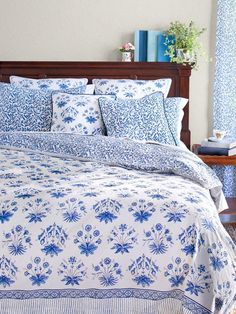 a blue and white bed in a bedroom