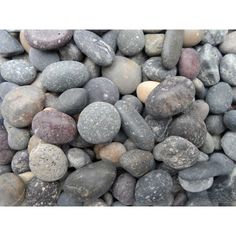 some rocks are laying on top of each other in different colors and sizes, all together