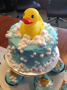 a baby shower cake with a rubber ducky on top