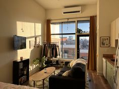 a living room filled with furniture next to a window