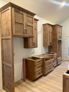 a kitchen with wooden cabinets and drawers in the middle of an unfinished flooring area