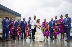 a bride and groom posing with their wedding party