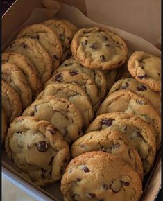 a box full of chocolate chip cookies sitting on top of a table