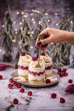 a person is cutting into some desserts on a plate with christmas decorations in the background