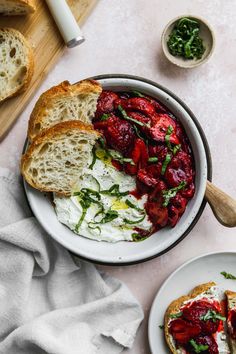 a bowl filled with bread and strawberries on top of a table