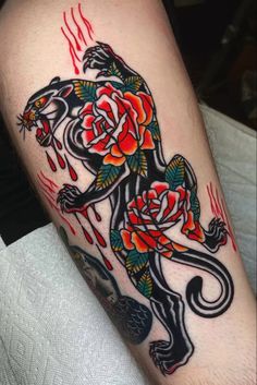 a tattoo on the leg of a man with roses and a lion in it's body