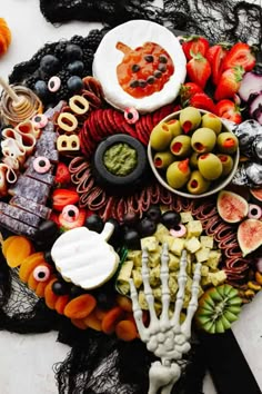 a table topped with lots of halloween food