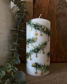 a white candle sitting on top of a table