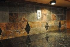 a kitchen with granite counter tops and tile backsplash