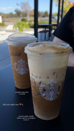 two cups of coffee sitting on top of a table