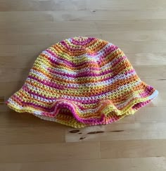 a crocheted hat sitting on top of a wooden floor