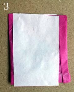 a piece of white paper with pink tape on it