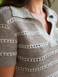 a close up of a woman wearing a sweater with holes in the front and back