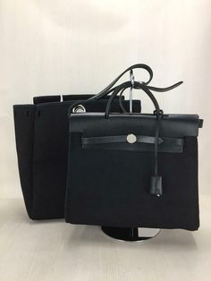 Auth HERMES 2Way Bag Herbag Purse Canvas Black used from Japan Description Condition: B (Good condition but signs of small scratches and / or stains) Color Black Material Canvas Size Handle20cm W29cm H23.5cm D10.5cm General: signs of wear Payment We only accept PayPal payments. Please pay within 5 days after auction is finished. Shipping Shipping Cost Shipping Method Asia, Middle East America,Canada Australia,Mexico Europe Russia Other Shipping Duration Shipping Method Asia, Middle East America, Office Bags With Leather Handles In Pouch Shape, Office Pouch Bag With Leather Handles, Office Pouch Bags With Leather Handles, Black Tote Briefcase, Black Travel Bag With Handles, Black Pouch Bag With Leather Handles, Classic Black Bags With Leather Handles, Black Pouch Bag With Handles, Black Top Handle Bag With Leather Handles