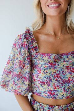 Need a little something to sweeten up your closet? We recommend the Instantly Perfect Multicolored Floral Cropped Blouse! This eye-catching blouse is designed to add a playful and vibrant touch to your everyday outfits, blending a lively floral print with a modern cropped silhouette. Crafted from lightweight, breathable fabric, this blouse features a rich multicolored floral pattern that exudes a fresh and summery vibe. The cropped design offers a flattering fit that pairs effortlessly with high Spring Multicolor Puff Sleeve Blouse, Multicolor Puff Sleeve Blouse For Spring, Multicolor Puff Sleeve Tops For Spring, Spring Multicolor Square Neck Tops, Multicolor Printed Puff Sleeve Blouse, Cute Fitted Spring Blouse, Multicolor Square Neck Tops For Spring, Cute Fitted Blouse For Spring, Casual Multicolor Blouse For Garden Party