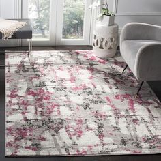 a white and pink rug in a living room