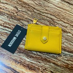 Brand: Steve Madden Color: Mustard Yellow Size: 4 3/4” (W) X 1/2” (D) X 3 3/4” (H) Approx Closure: Snap, Zipper Front Cardholders Back Cardholders Gold Metal Details Material: Saffiano Leather Scratch Resistant, Very Durable, Can Repel Water And Stains, And Easy To Clean. Condition: Brand New With Original Tags Same Day Shipping Via Usps Steve Madden Mustard Yellow Snap Cardholder Wallet Saffiano Leather Trendy Yellow Wallet For Everyday Use, Yellow Casual Wallet For Everyday Use, Trendy Yellow Wallets For Everyday Use, Trendy Yellow Wallet For Daily Use, Yellow Wallet For Everyday Use, Classic Yellow Rectangular Wallet, Yellow Wallets With Card Slots For Daily Use, Rectangular Yellow Everyday Wallet, Leather Wallets With Gold-tone Hardware