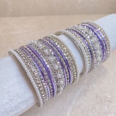 2 Small stacks of Silver bangles with Pearl and clear stonework details finished with soft pretty purple, sparkling silvers and our favourite Daisy Bangle in the centre to add that sparkle. Ready to Ship! Packed in small box ( no roll ) Purple Bangle For Wedding, Purple Rhinestone Bracelets As Gift, Purple Rhinestones Jewelry For Anniversary, Purple Rhinestone Bracelets For Gifts, Purple Rhinestone Bracelets Perfect For Gifts, Purple Rhinestone Jewelry For Anniversary, Adjustable Purple Round Bangle, Adjustable Round Purple Bangle, Adjustable Purple Rhinestone Jewelry