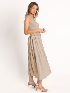 Channel your inner bohemian goddess with our Feminine Frills Smocked Maxi Dress in stunning neutral. Designed with delicate smocking and feminine frills, this dress is perfect for any occasion. Embrace your free-spirited style in comfort and style. (Now that's a dress worth twirling in!) Size Guide: Model is 5’6” tall, and has a 33.2” bust, 26.4” waist, & 35.2” hips. She is wearing a S / US 4 / AU 8. This dress is true to size. Material: 62% Rayon. 38% Polyester Feature: Square neckline. Sleeveless. Maxi length. Smocked Body. Flowy fit. Care Instructions: Machine wash / Cold hand wash Casual Ruched Smocked Dress For Gatherings, Bohemian Smocked Dress With Tiered Skirt, Casual Smocked Dress For Spring Gatherings, Bohemian Smocked Midi Dress With Ruffle Hem, Bohemian Beige Maxi Dress With Smocked Back, Feminine Beige Maxi Dress With Smocked Bodice, Sleeveless Beige Smocked Dress, Beige Feminine Maxi Dress With Smocked Bodice, Beige Sleeveless Smocked Dress