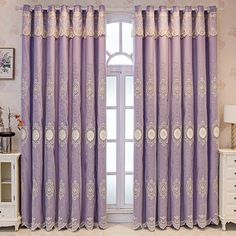 the purple curtains are hanging on the window