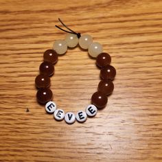 a beaded bracelet with the word eve spelled in white letters on top of it