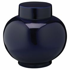 a dark blue vase with a black lid is shown in front of a white background