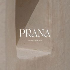 the logo for prana yoga studio is shown in white letters on a beige wall