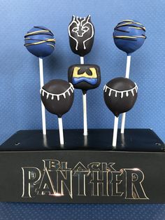 the black panther cake pops are on top of each other in front of a blue background