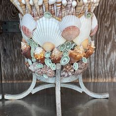 an arrangement of seashells and shells on a stand