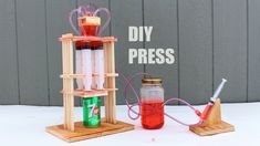 an experiment set up on a table with liquid in it and two bottles attached to the stand