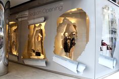 an image of a store window display with mannequins in the front and behind it