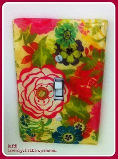 a colorful light switch cover with flowers on it