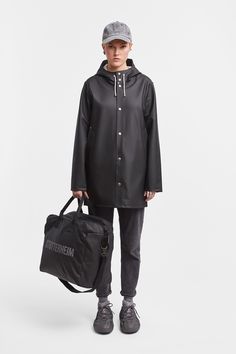 Stockholm Raincoat Black | STUTTERHEIM US Urban Outerwear With Adjustable Hood, Winter Black Raincoat With Storm Flap, Urban Outerwear With Adjustable Hood For Everyday, Black Outerwear With Double-lined Hood For Travel, Black Travel Outerwear With Double-lined Hood, Black Techwear Outerwear For Travel, Hooded Black Outerwear With Storm Flap, Functional Black Raincoat For Travel, Functional Black Travel Raincoat