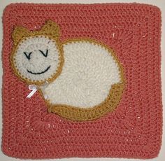 a crocheted square with a cat on it