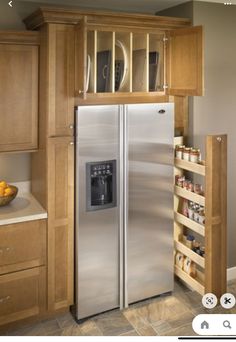 a stainless steel refrigerator freezer sitting in a kitchen next to wooden cabinets and drawers