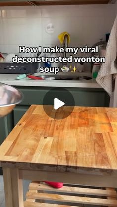 a wooden table sitting in a kitchen next to a stove top oven and countertop