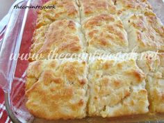 a pan filled with bread sitting on top of a red and white checkered table cloth