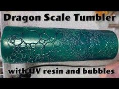 the dragon scale tumbler is green with resin and bubbles on it's side