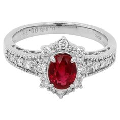 A JGGL Certified Burmese Ruby weighing around 1 carat is set along with 0.26 carat of white brilliant round diamond. The ring is made in PT 900 and has been manufactured in Japan. The image of the certificate can be found along with the images of the ring. The details of the diamond are mentioned below: Color: D Clarity: Vvs Oval Ruby Ring With Vvs Clarity Diamond, Oval Ruby Ring With Diamond Cut In Platinum, Classic Ruby Ring With Vvs Clarity Diamond, 14k White Gold Ruby Ring With Halo Setting, Formal Ruby Ring With Brilliant Cut Moissanite, Vvs Clarity Ruby Ring With Diamond, Formal Moissanite Ruby Ring With Brilliant Cut, Formal Brilliant Cut Moissanite Ruby Ring, Exquisite Brilliant-cut Ruby And Diamond Ring