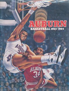 an advertisement for the auburn basketball team in front of a crowd with two men playing basketball