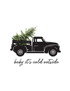 a black truck with a christmas tree in the bed that says baby it's cold outside