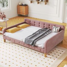 a bed that is in the middle of a room with a rug on the floor