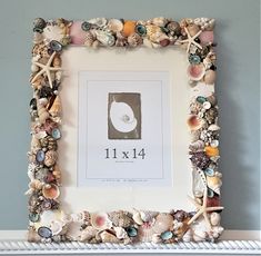 a frame with shells and seashells on it