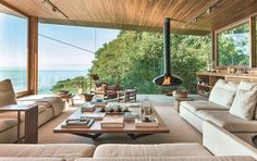 a living room filled with lots of furniture next to a large window covered in wood