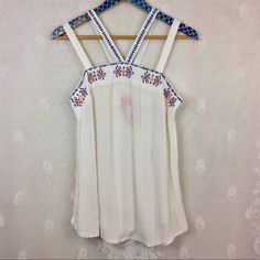 Nwt No Issues. Xhilaration White Lightweight Gauzey Strappy Sleeveless Blouse Tank Top Juniors Size Medium. Blue And Multicolor Embroidery Along Bust Line, Strap, And Cute Little White Balls Along The Bottom Hem. Length 27 In, Armpit To Armpit 16 In. White Tank Top For Spring And Summer, White Cami Top For Beach Season, White Festival Tank Top, White Camisole Tank For Vacation, White Summer Camisole For Vacation, White Tank Camisole For Vacation, White Stretch Bohemian Top, White Bohemian Stretch Top, White Summer Vacation Camisole