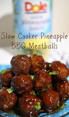 slow cooker pineapple bbq meatballs on a blue plate next to a bottle of booze