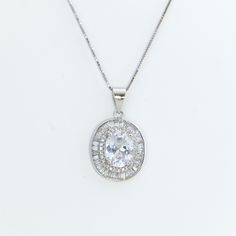 "This elegant pendant has a gorgeous 3 ct oval cut center diamond CZ surrounded by accent baguette diamond stones. It is so classic and eye-catching. A great gift for your loved ones or yourself.  ✩ Made of solid 925 fine silver ✩ Pendant measuring 10mm in diameter.  ✩ Finest diamond simulants with a breathtaking level of brightness like real diamonds ✩ Complimentary 16\" sterling silver chain with a 2\" extender ✩ Box chain & Spring clasp closure ✩ Ship in a beautiful gift box More blings from Joylene: https://www.etsy.com/shop/joylenedesign We only choose the finest diamond simulants (CZ 5A) on the market, with a breathtaking level of brightness like real diamonds. Our jewelry can be found in stores and boutiques in Illinois, Indiana and Wisconsin. We always believe that if we invested a Baguette Diamond Necklace, Rose Gold Promise Ring, Clean Sterling Silver, Sterling Silver Promise Rings, Halo Pendant, Elegant Pendant, Double Halo, Diamond Simulant, Necklace Statement