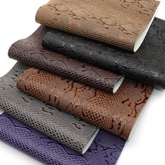 a group of different colored leathers sitting on top of each other